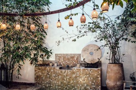 Wellness Travel - Traditional oriental hammam pool on exotic resort spa terrace decorated with lush plants and stylish lanterns
