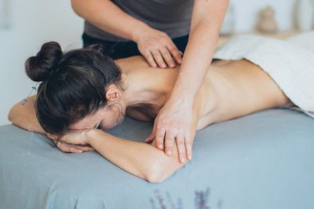 Spa - Woman Lying on Bed While Having A Massage