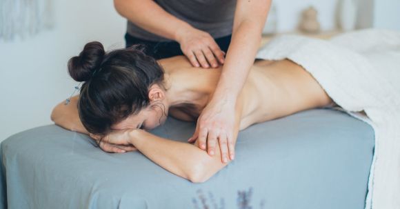 Spa - Woman Lying on Bed While Having A Massage