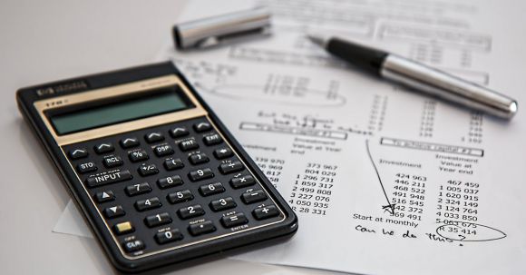 Budget - Black Calculator Near Ballpoint Pen on White Printed Paper