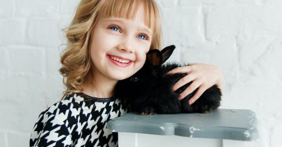 Family Attractions - Girl Holding Black Rabbit