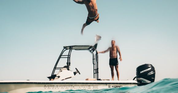 Luxury Travel - Photo of Man Jumping from Boat to the Sea