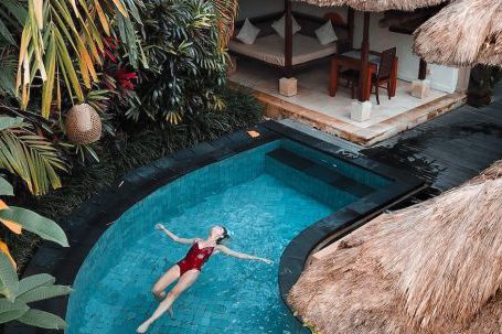 Hotel - Woman Soaking on the Swimming Pool