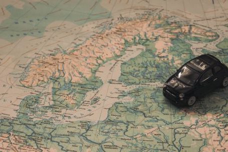 Car Travel - Black Toy Car on World Map Paper