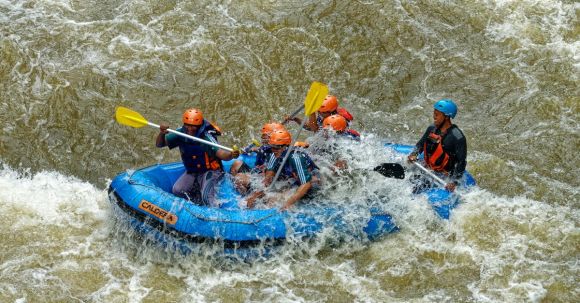 Rafting - Group Of Men Paddling While Inside Inflatable Boat