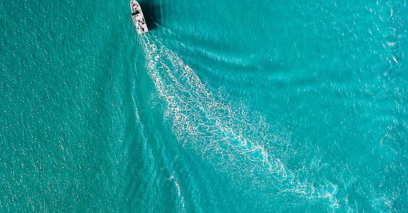 Yacht Travel - Drone view of yacht sailing in sea water