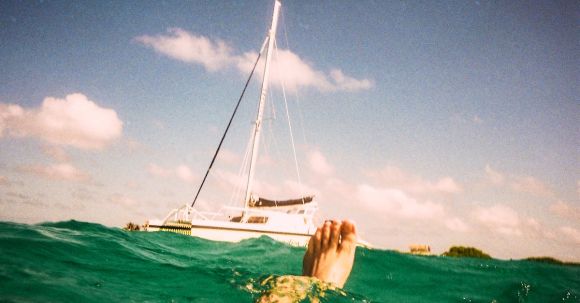 Yacht Travel - Man Underwater With White Yacht Beside