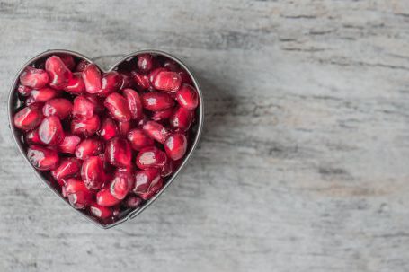 Nutrition - Silver Heart Bowl Filled of Red Pomegranate Seeds