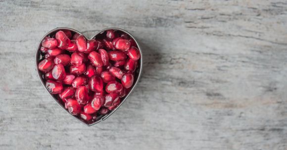 Nutrition - Silver Heart Bowl Filled of Red Pomegranate Seeds